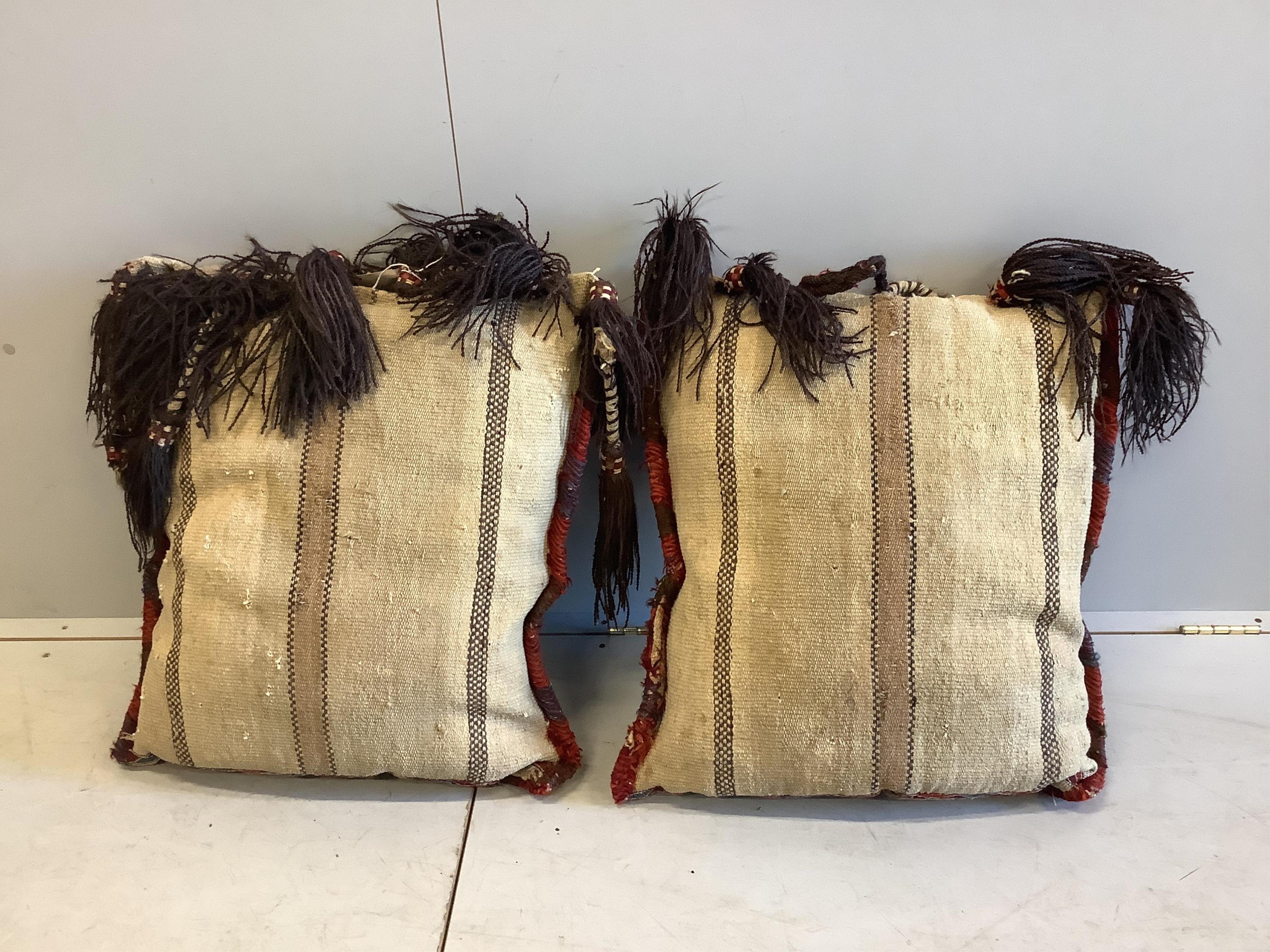 Two Kilim polychrome camel bags, now as cushions, each 65 x 60cm. Condition - fair